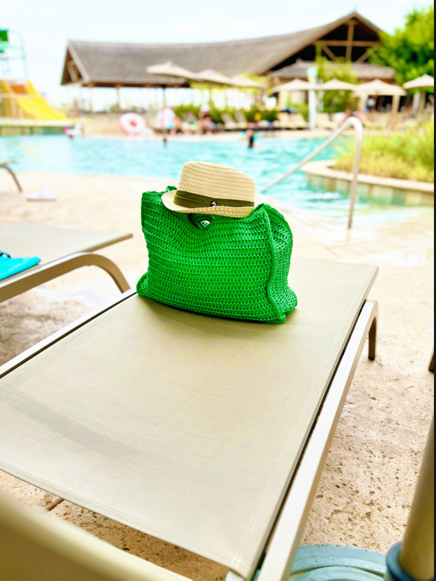 sun lounger and green bag